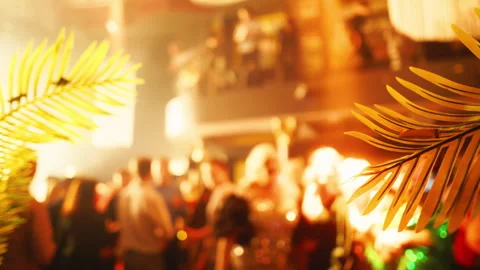 Blurred crowd at an entertaining event with palm tree in heat Stock Footage 275157753
