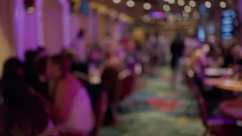 Blurred crowd inside vibrant restaurant lounge with warm bokeh lights and Stock Footage 345528149