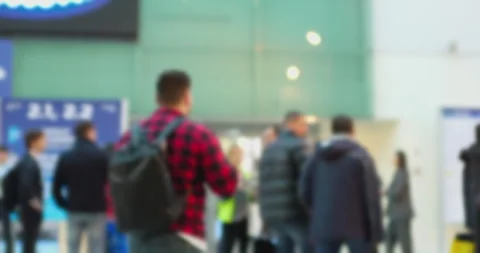 Blurred crowd navigating busy exhibition hall walkways Stock Footage 302273103