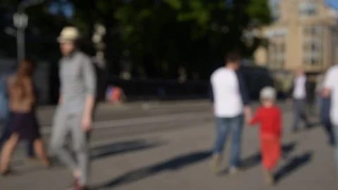 Blurred crowd of people are walking along the sidewalk near the road. Stock Footage 108774989