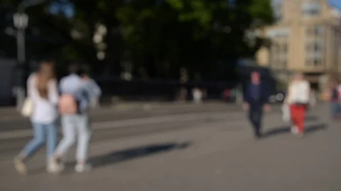 Blurred crowd of people are walking along the sidewalk near the road. Stock Footage 108775004