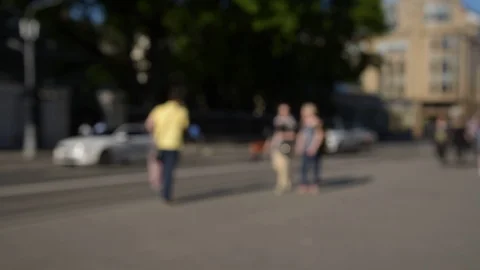 Blurred crowd of people are walking along the sidewalk near the road. Stock Footage 108775010