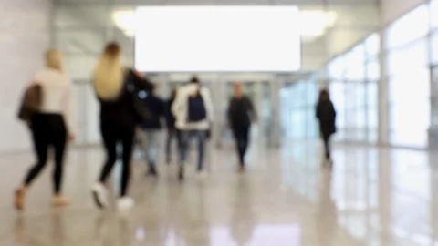 Blurred crowd of people at a convention passing hallway Stock Footage 120139133