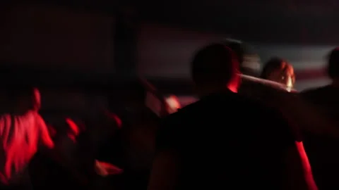 Blurred crowd of people dancing at a vibrant party with colorful lights and Stock Footage 313639605