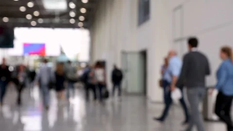Blurred crowd of people passing by in a conference hallway Stock Footage 119823780