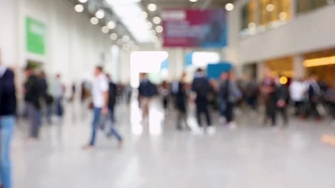 Blurred crowd of people passing by in a convention hall Stock Footage 123835151