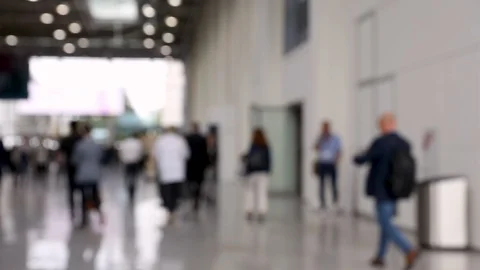 Blurred crowd of people passing by in hallway of convention center Stock Footage 119022080