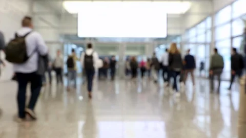 Blurred crowd of people passing through shot in a convention hallway Stock Footage 122204188