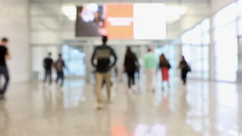 Blurred crowd of people passing through convention center hallway Stock Footage 123835334