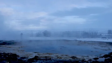 Blurred crowd of people standing behind hot springs of geothermal Geysir Stock Footage 93471129