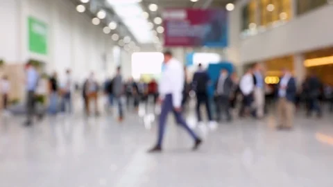 Blurred crowd of people walking around convention hall Stock Footage 123280978