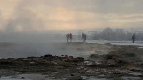 Blurred crowd of people walking behind hot springs of geothermal Geysir Stock Footage 93470546