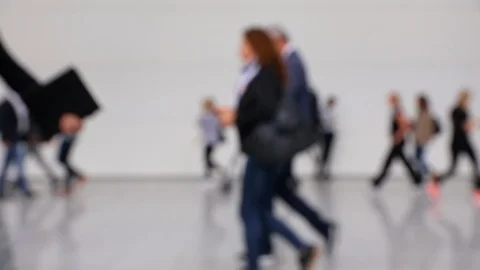 Blurred crowd of people walking by in a convention hallway Stock Footage 120401638