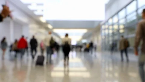 Blurred crowd of people walking through shot in one direction in a hallway Stock Footage 119022029