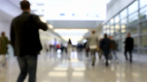 Blurred crowd of people walking through shot in one direction at a conference Stock Footage 123281077