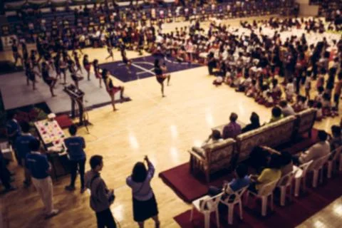 Blurred crowd of people watching performance in the hall Stock Photos