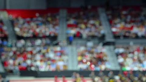 Blurred crowd of spectators sitting in stadium stands during large public Stock Footage 338318514