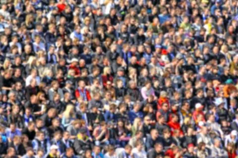 Blurred crowd of spectators on a stadium tribune at a sporting event Stock Photos