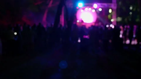 Blurred, defocus background of silhouettes of crowd of people dancing Stock Footage 134717349