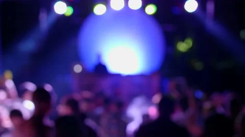 Blurred, defocus background of silhouettes of crowd of people dancing at Full Stock Footage 134730407