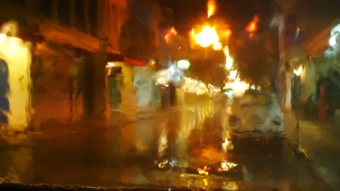 Blurred defocus footage of raining on front mirror of car parking on street   Video stock 98895487