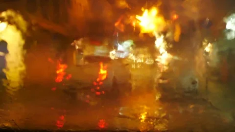 Blurred defocus footage of raining on front mirror of car parking on street   Stock Footage 98895534