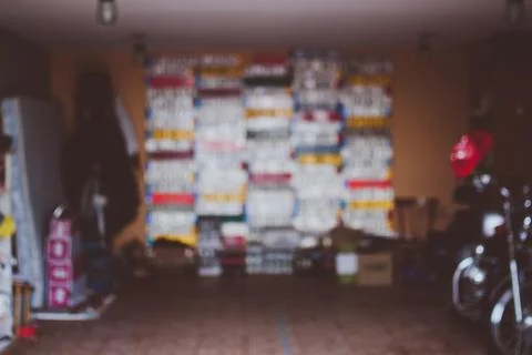 Blurred defocused background of a garage wall with european license plates.  Stock Photos