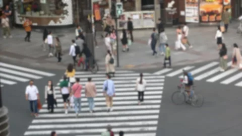 Blurred defocused of Elevated view of Japanese people crossing road intersection Stock Footage 248732272