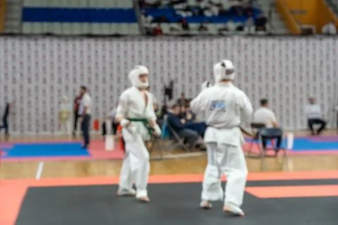Blurred defocused image with two karate practitioners sparring on a tatami ma Photos