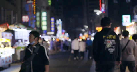 Blurred defocused view of People Walking at Liou He Night Markets in Kaohsiun Stock Footage 241908055