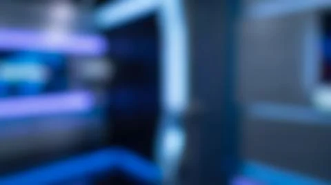 Blurred defocussed background of dark high tech news broadcast television stu Stock Photos