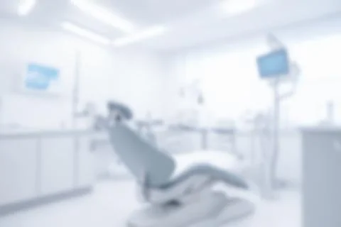 Blurred dentist office interior with empty chair, dental instruments, moder.. Stock Photos
