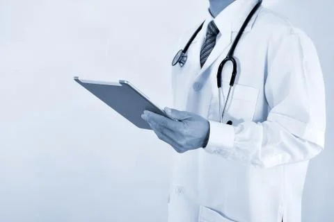 Blurred Doctor working on a digital tablet Stock Photos