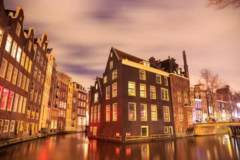 Blurred dramatic night sky over traditional historical buildings on a canal, by Fotos de archivo