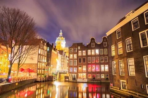 Blurred dramatic night sky over traditional historical buildings on a canal, by Fotos de archivo