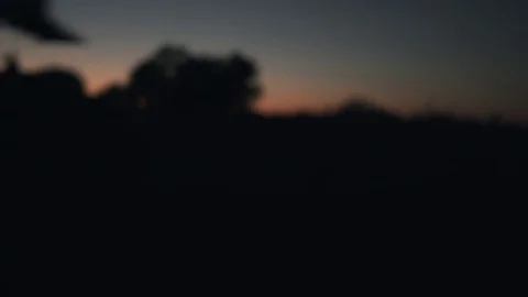 Blurred driving plate side view moving through hills and fields in night Stock Footage 82989894