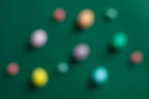 Blurred Easter background with colorful eggs on green backdrop 스톡 사진