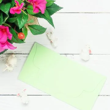 Blurred Easter composition. Pink flowers green envelop tree white bunny rabbits Stock Photos