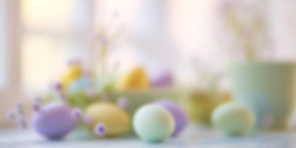 Blurred Easter themed background with pastel eggs and spring flowers. Soft .. Stock Photos