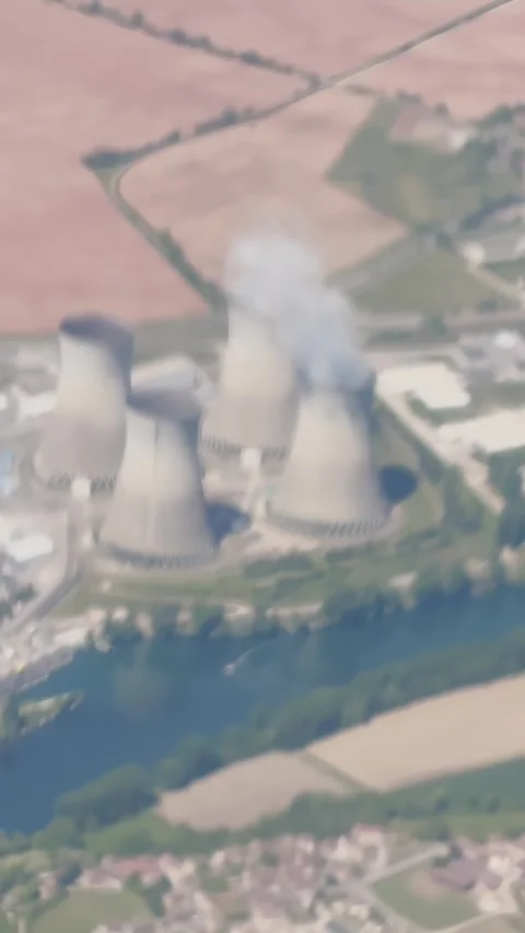 Blurred effect aerial shot of a nuclear power plant with cooling towers and Stock Footage 337228927