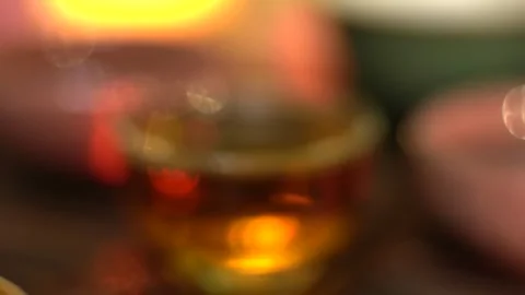 Blurred effect on Chinese tea cups during a traditional tea ceremony at evening Stock Footage 322612473