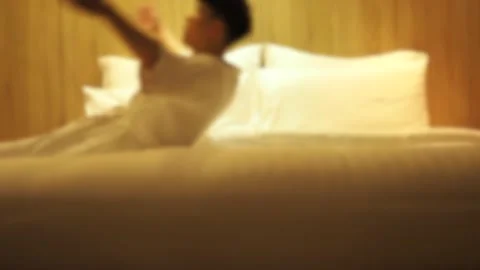 Blurred effect on man falling asleep on bed, looking tired Stock Footage 129801447