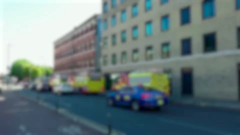 Blurred emergency vehicles and fire engines along busy urban street during 動画素材 344104120