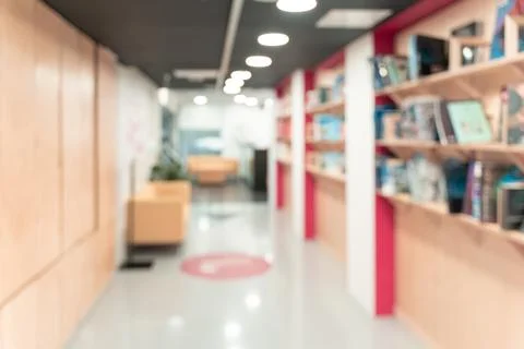 Blurred empty open space corridor. Abstract light bokeh at office interior Stock Photos