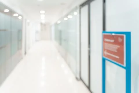 Blurred empty open space corridor. Abstract light bokeh at office interior Stock Photos