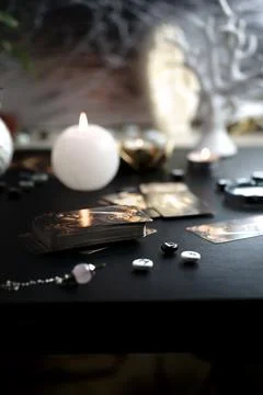 Blurred esoteric magic objects tarot cards on witch table altar Stock Photos