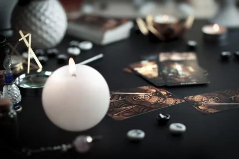 Blurred esoteric magic objects tarot cards on witch table altar Stock Photos