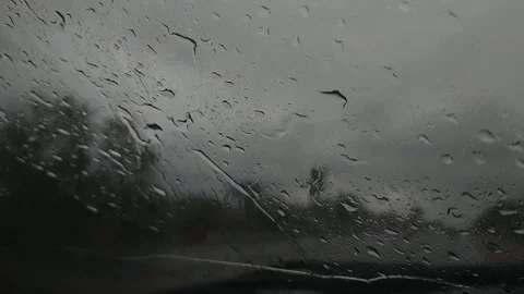 Blurred evening traffic trough window mirror with rain outside. Video stock 157101761