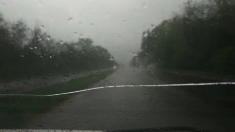 Blurred evening traffic trough window mirror with rain outside Stock Footage 167472726