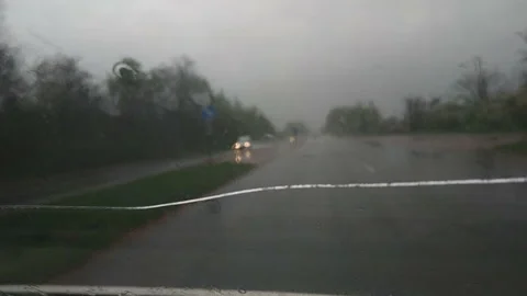 Blurred evening traffic trough window mirror with rain outside Stock Footage 167472767
